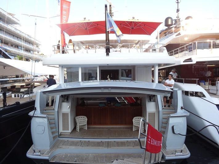 a boat with a flag on the roof aboard UNEXPECTED Yacht for Charter