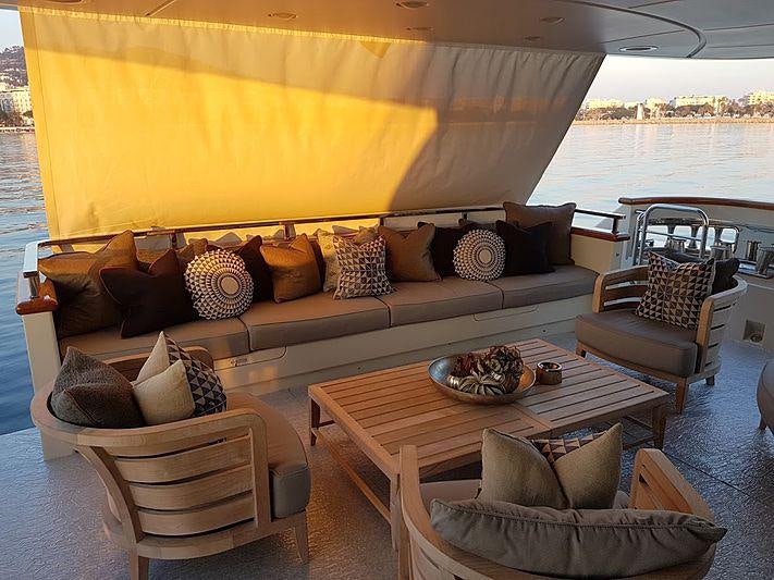 a living room with a couch and a table aboard AWAY Yacht for Charter