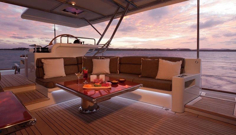 a living room with a large sofa aboard GENEVIEVE Yacht for Charter