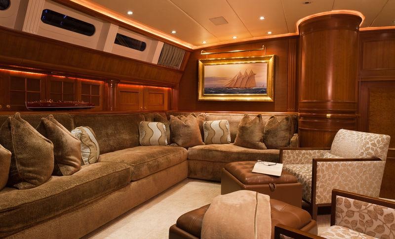 a large living room with a large fireplace aboard GENEVIEVE Yacht for Charter