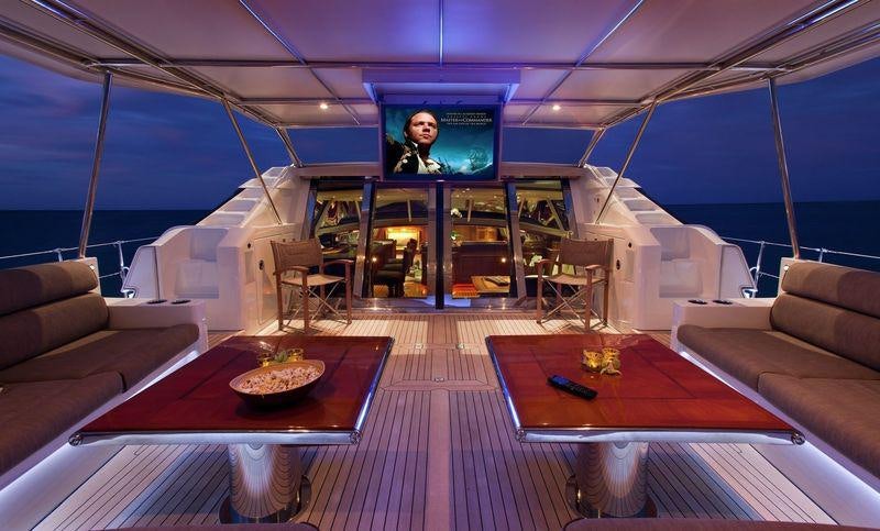 a room with a table and couches aboard GENEVIEVE Yacht for Charter