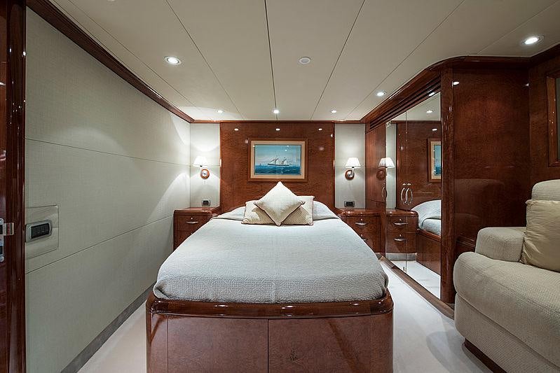 a hotel room with a bed and a chair aboard THANDEKA Yacht for Charter