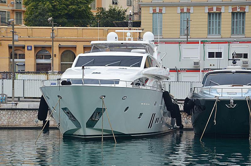 a couple of boats sit in a harbor aboard ARION Yacht for Charter
