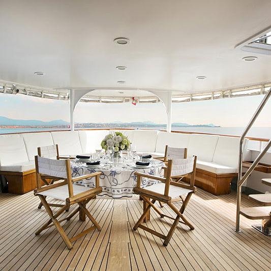 a room with a table and chairs aboard LADY JERSEY Yacht for Charter