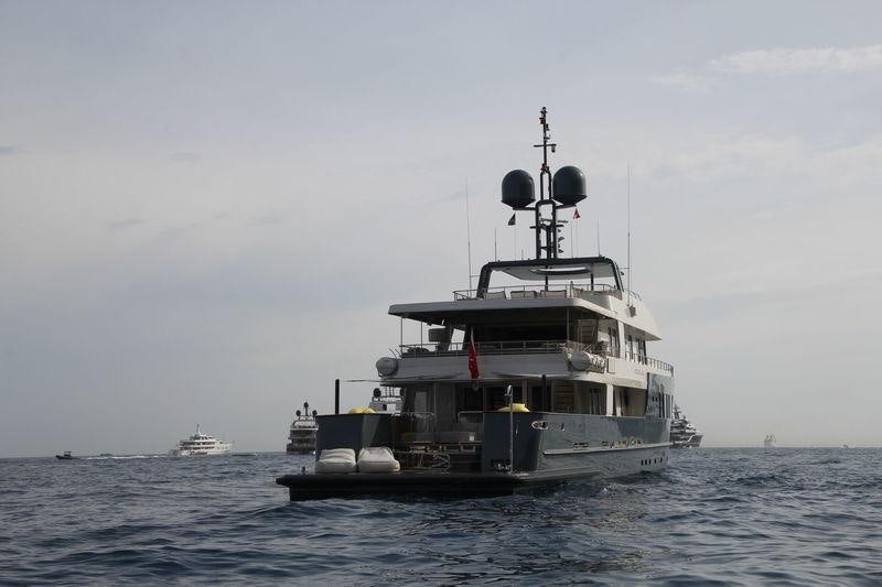 a boat in the water with Thomas Point Shoal Light in the background aboard ZULU Yacht for Charter