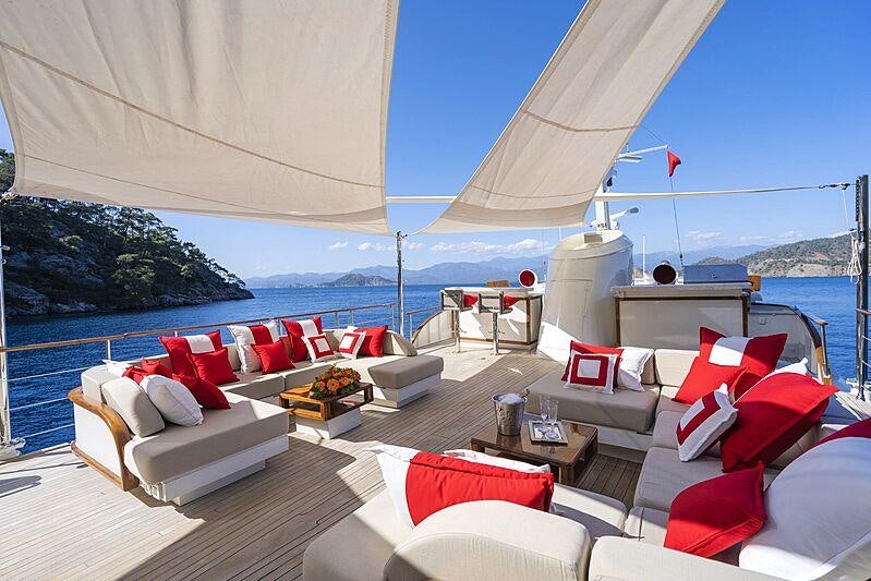 a large white lounge chair next to a large body of water aboard ALHAMBRA Yacht for Sale