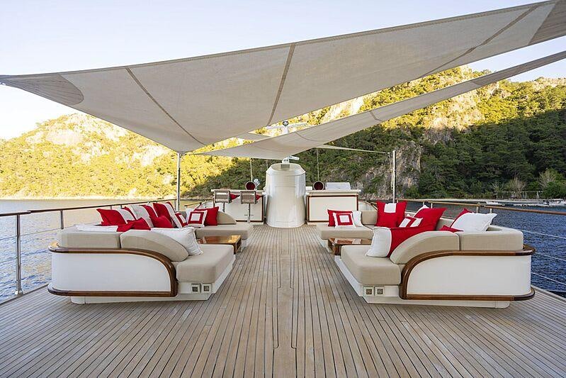 a large white tent with a couch and a table and chairs on a deck aboard ALHAMBRA Yacht for Sale
