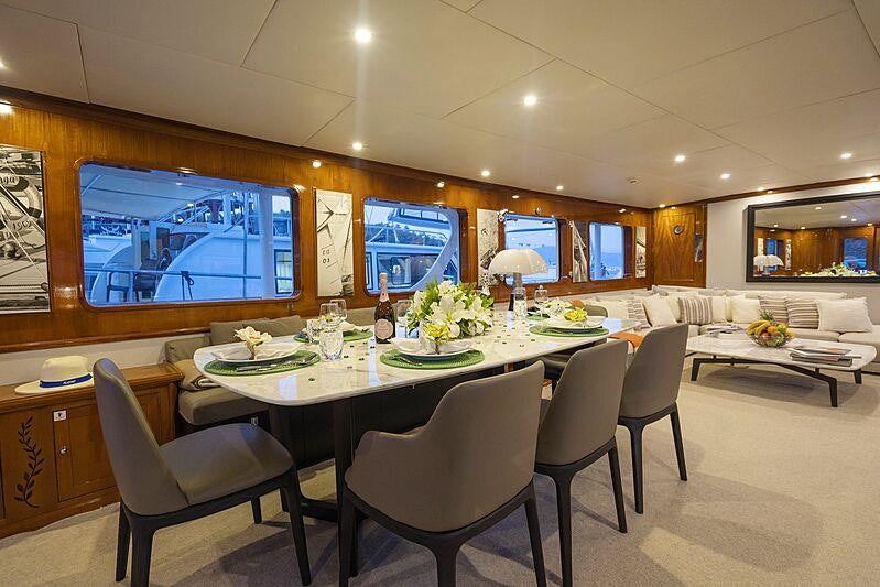 a large room with a table and chairs aboard ALHAMBRA Yacht for Sale