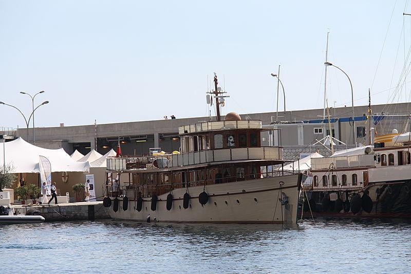 a large boat docked at a pier aboard OVER THE RAINBOW OF LONDON Yacht for Charter