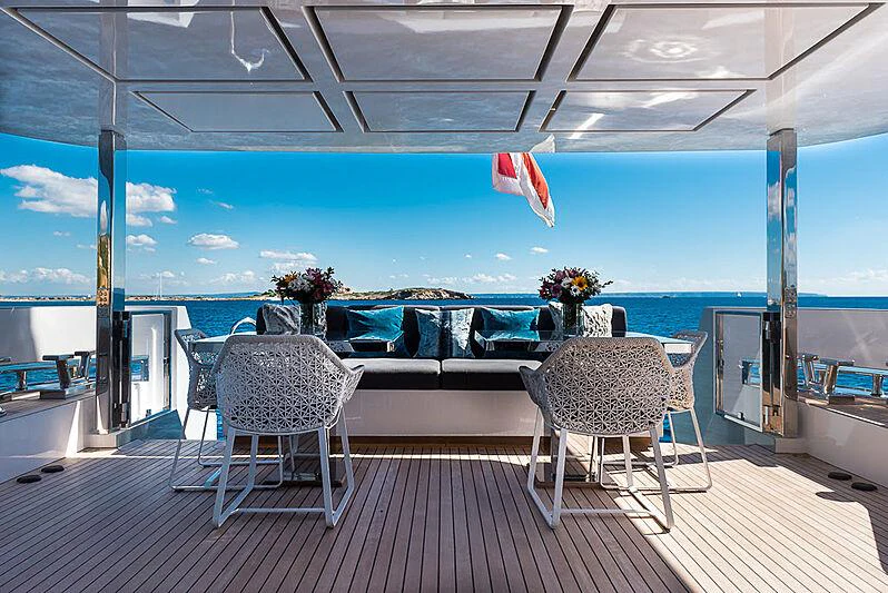 a deck with chairs and a table on it aboard CINQUANTA-50 Yacht for Charter