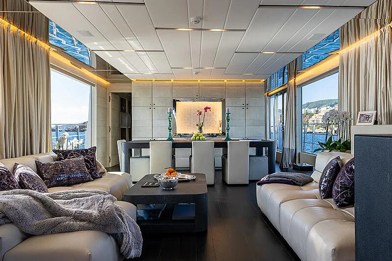 a living room with a large window aboard CINQUANTA-50 Yacht for Charter