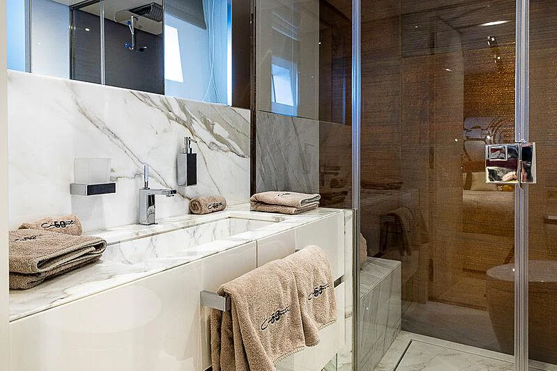 a bathroom with a large mirror aboard CINQUANTA-50 Yacht for Charter