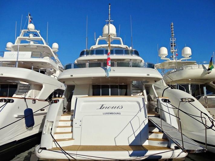 a group of boats in a harbor aboard INOUIS Yacht for Charter