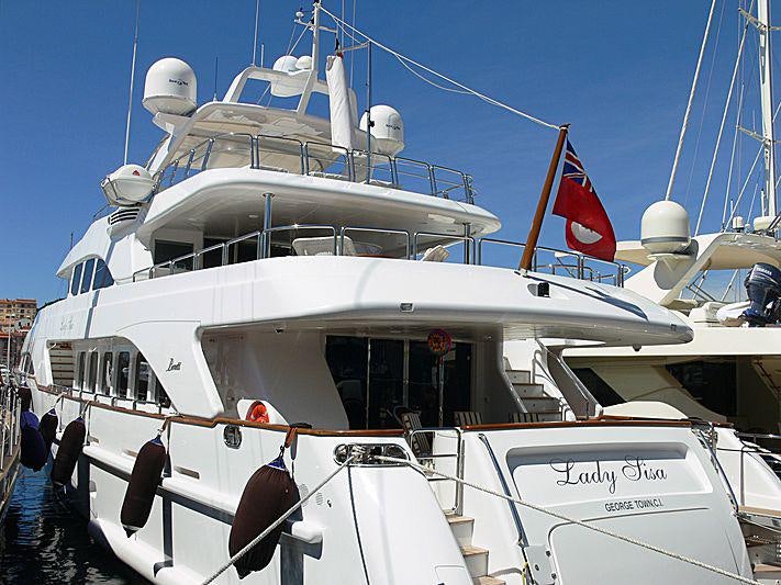 a large white boat with a red flag on it aboard HEAVEN CAN WAIT Yacht for Charter