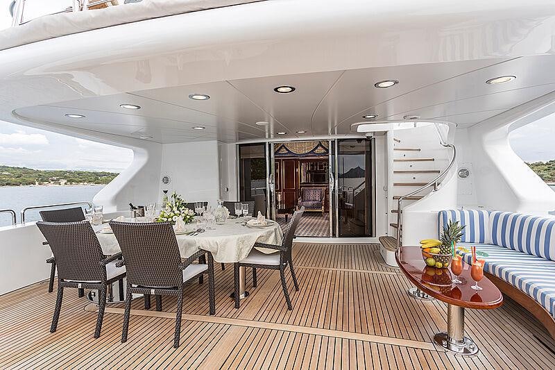 a large open house with a dining area and kitchen aboard FRIENDSHIP Yacht for Charter