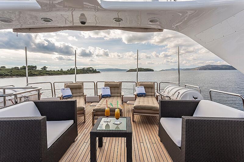 a table and chairs on a deck aboard FRIENDSHIP Yacht for Charter