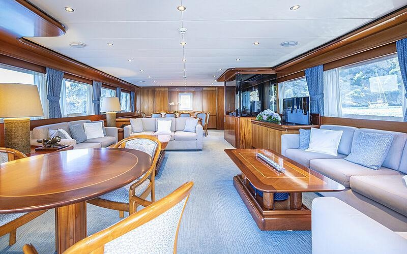 a living room with a table and couches aboard ALCOR Yacht for Charter
