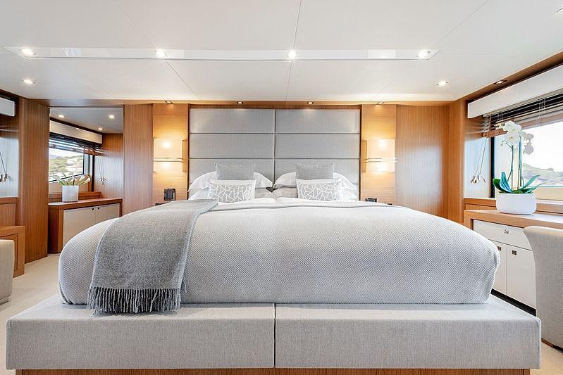 a bed with white sheets aboard OKSANCHIK Yacht for Charter