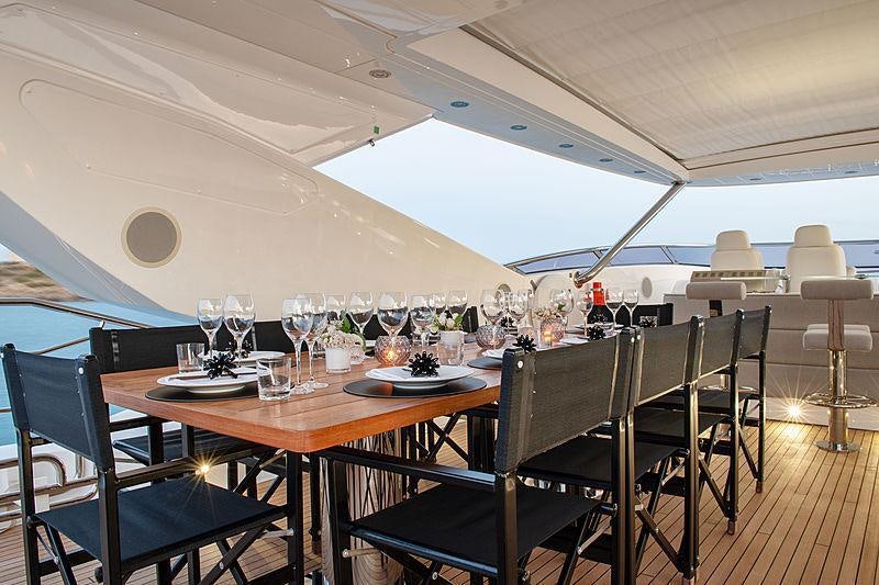 a table set for a dinner party aboard OKSANCHIK Yacht for Charter