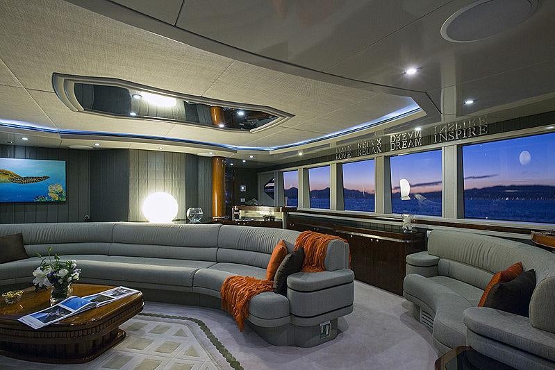 a living room with a large screen aboard PRINCESS ILUKA Yacht for Charter