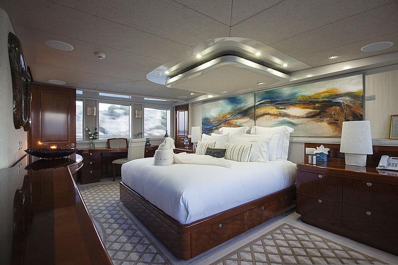 a bedroom with a bed and desk aboard PRINCESS ILUKA Yacht for Charter