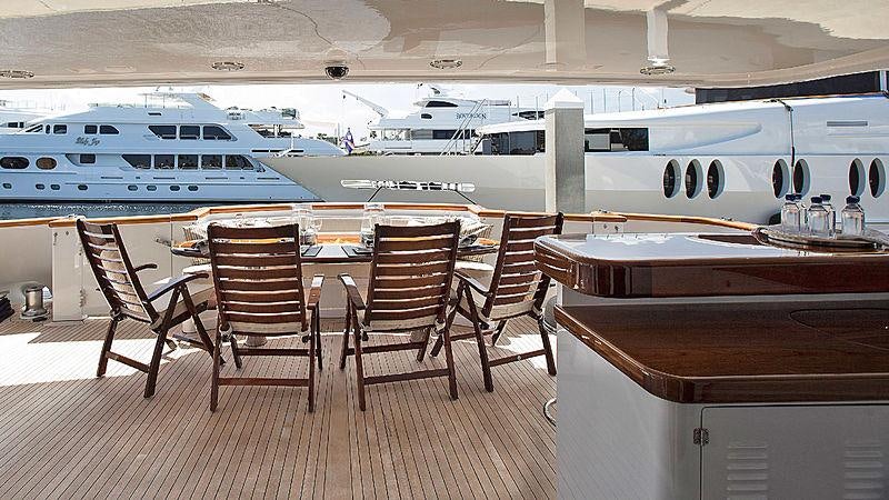 a room with a table and chairs aboard GITANA Yacht for Charter