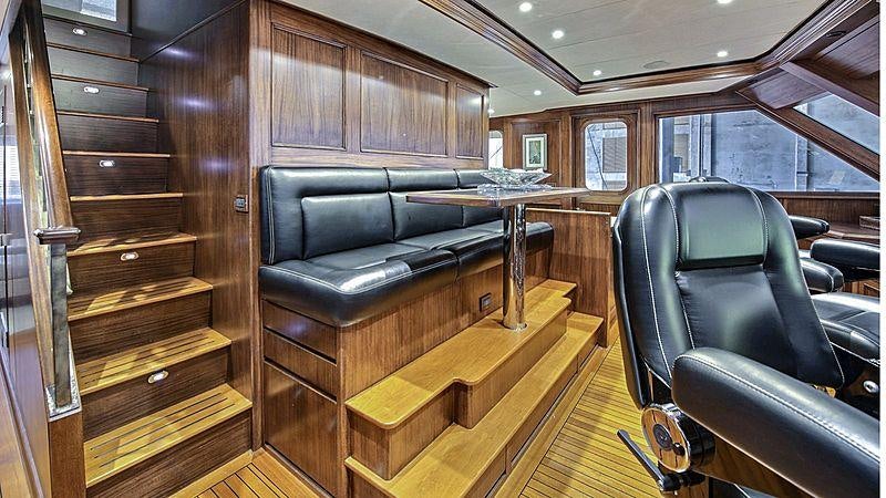 a leather couch in a room aboard GITANA Yacht for Charter