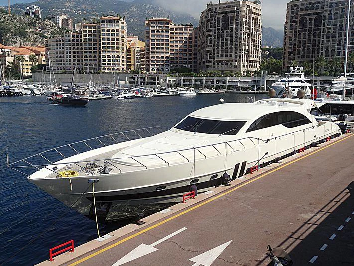 a white yacht in a harbor aboard GINEVRA Yacht for Charter