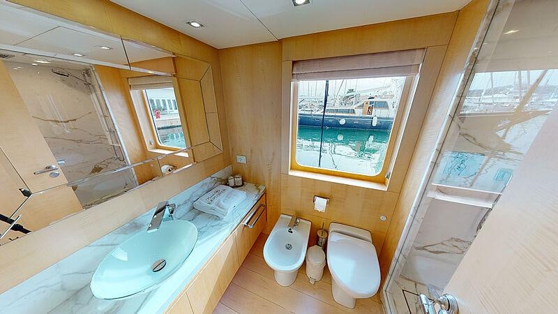 a bathroom with a tub sink and toilet aboard ATOM Yacht for Charter