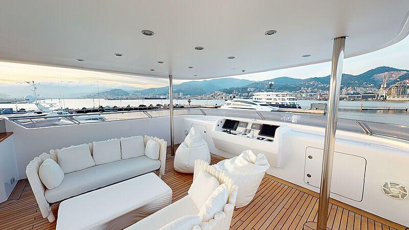 a room with a couch and a large window overlooking a city aboard ATOM Yacht for Charter