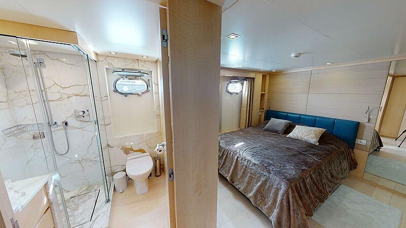 a bathroom with a bed and a shower aboard ATOM Yacht for Charter