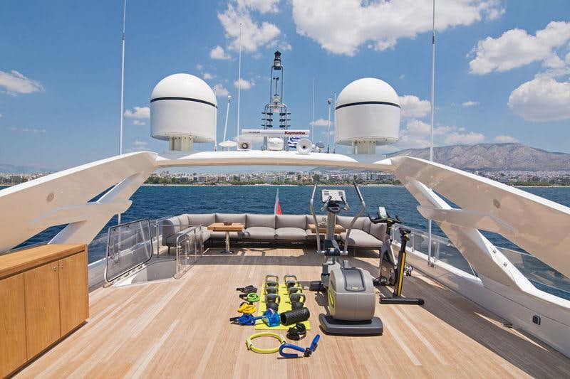 a deck with a deck and a large ship on it aboard WHISPER V Yacht for Charter