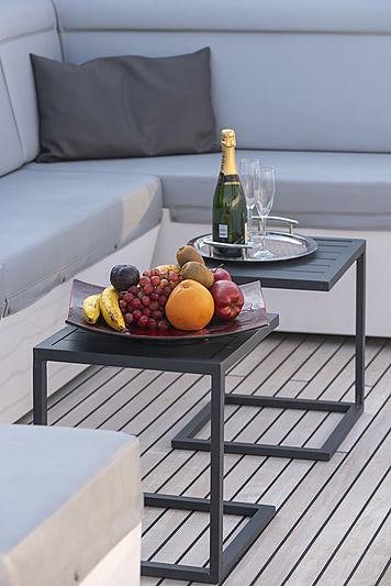 a table with fruit and wine on it aboard PROJECT STEEL Yacht for Charter