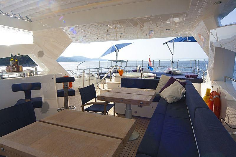 a boat with a table and chairs aboard ARAGO Yacht for Charter