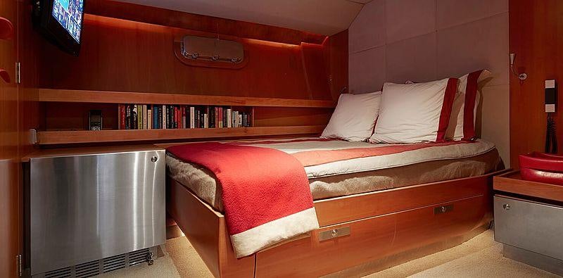 a bed with red sheets aboard SILVERTIP Yacht for Charter