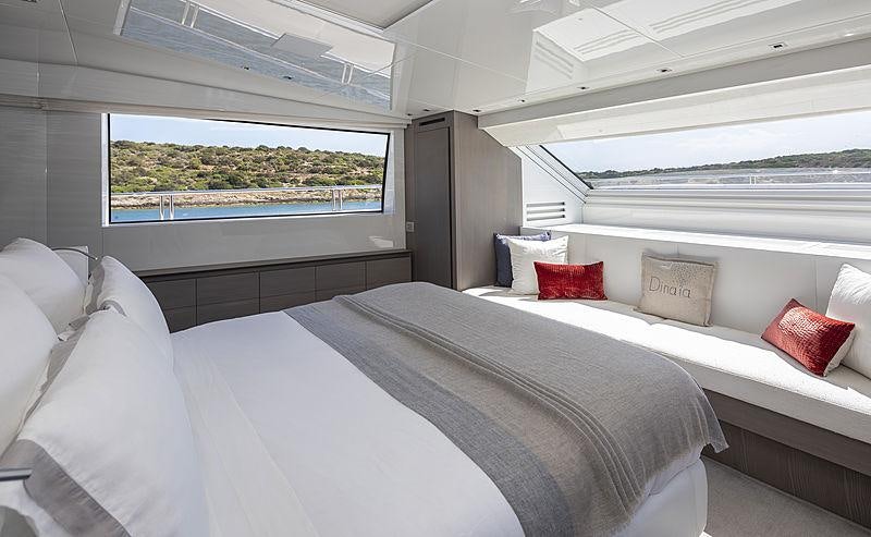 a room with a bed and pillows aboard DINAIA Yacht for Charter