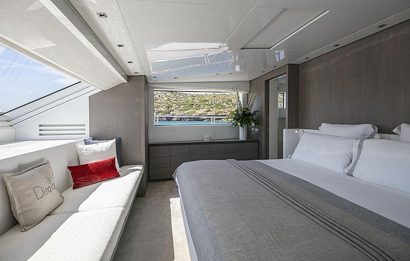 a room with a bed and a couch aboard DINAIA Yacht for Charter