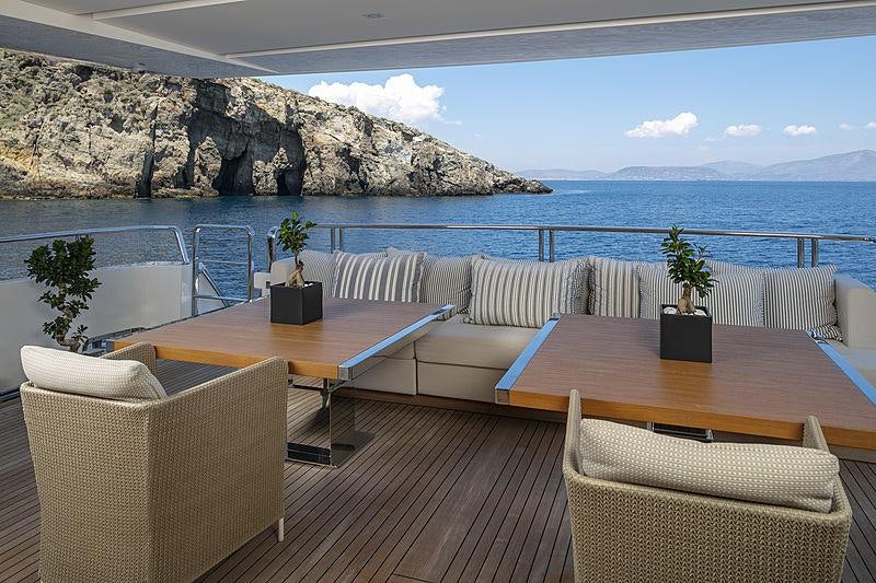 a table and chairs on a boat aboard DINAIA Yacht for Charter