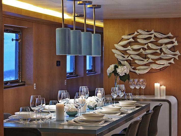 a dining room with a chandelier and a chandelier aboard SOUNION II Yacht for Charter