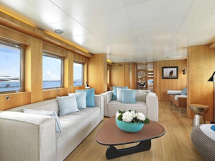 a living room with a couch and a table aboard SOUNION II Yacht for Charter