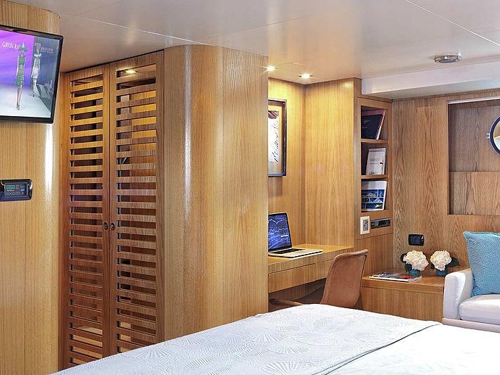 a room with a bed and a desk aboard SOUNION II Yacht for Charter
