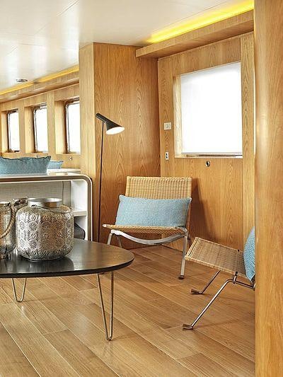 a chair and a table in a room aboard SOUNION II Yacht for Charter