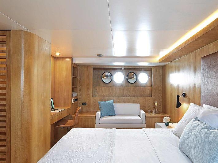 a room with a bed and a couch aboard SOUNION II Yacht for Charter