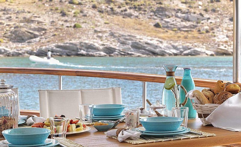 a table with dishes and food on it aboard SOUNION II Yacht for Charter