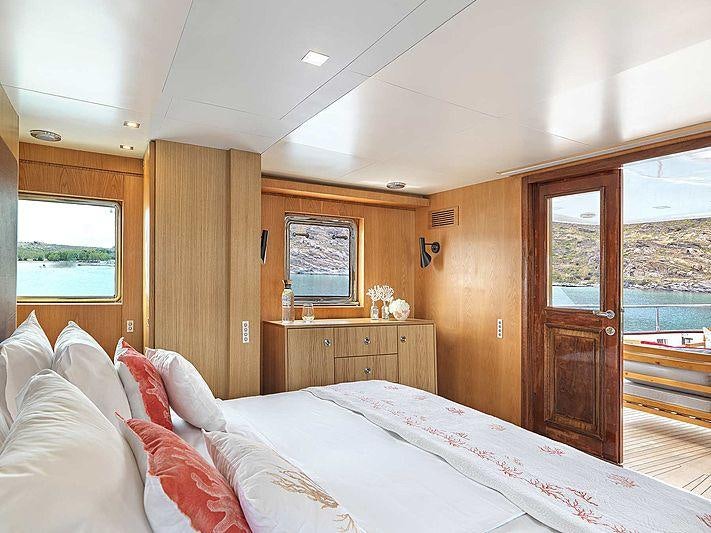 a bedroom with a large bed aboard SOUNION II Yacht for Charter