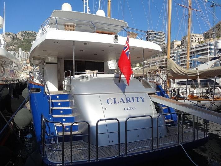 a boat with a flag on the front aboard CLARITY Yacht for Charter