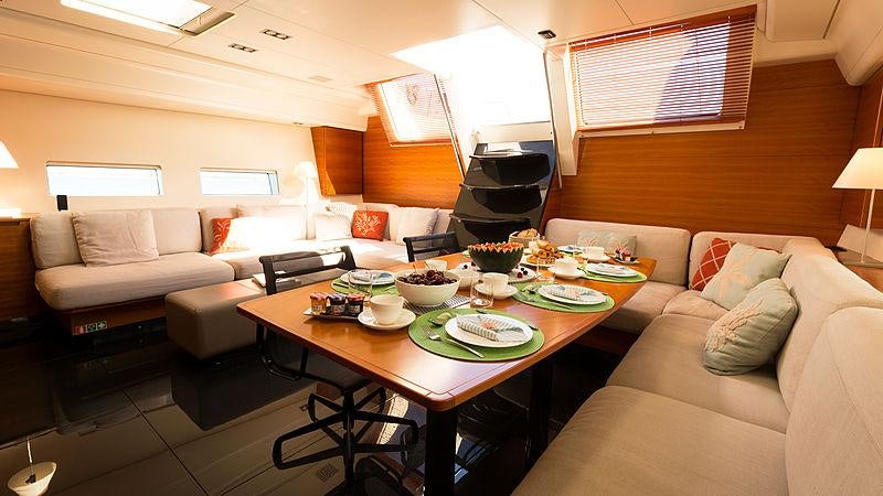 a living room with a table and couches aboard WALLY LOVE Yacht for Charter