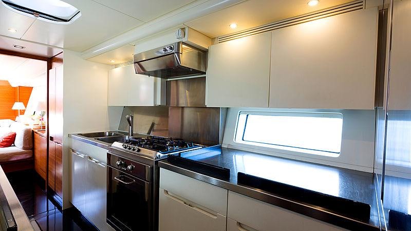 a kitchen with a stove and a microwave aboard WALLY LOVE Yacht for Charter