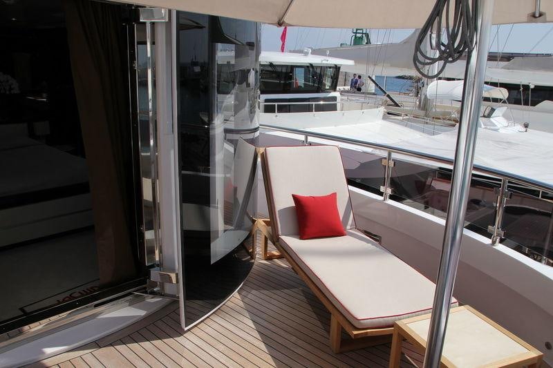 a room with a bed and a window aboard GATSBY Yacht for Charter