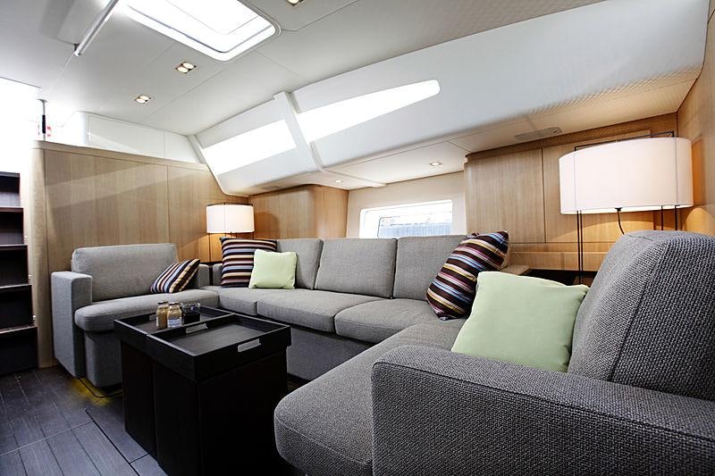 a living room with couches and a coffee table aboard YCH2 Yacht for Charter
